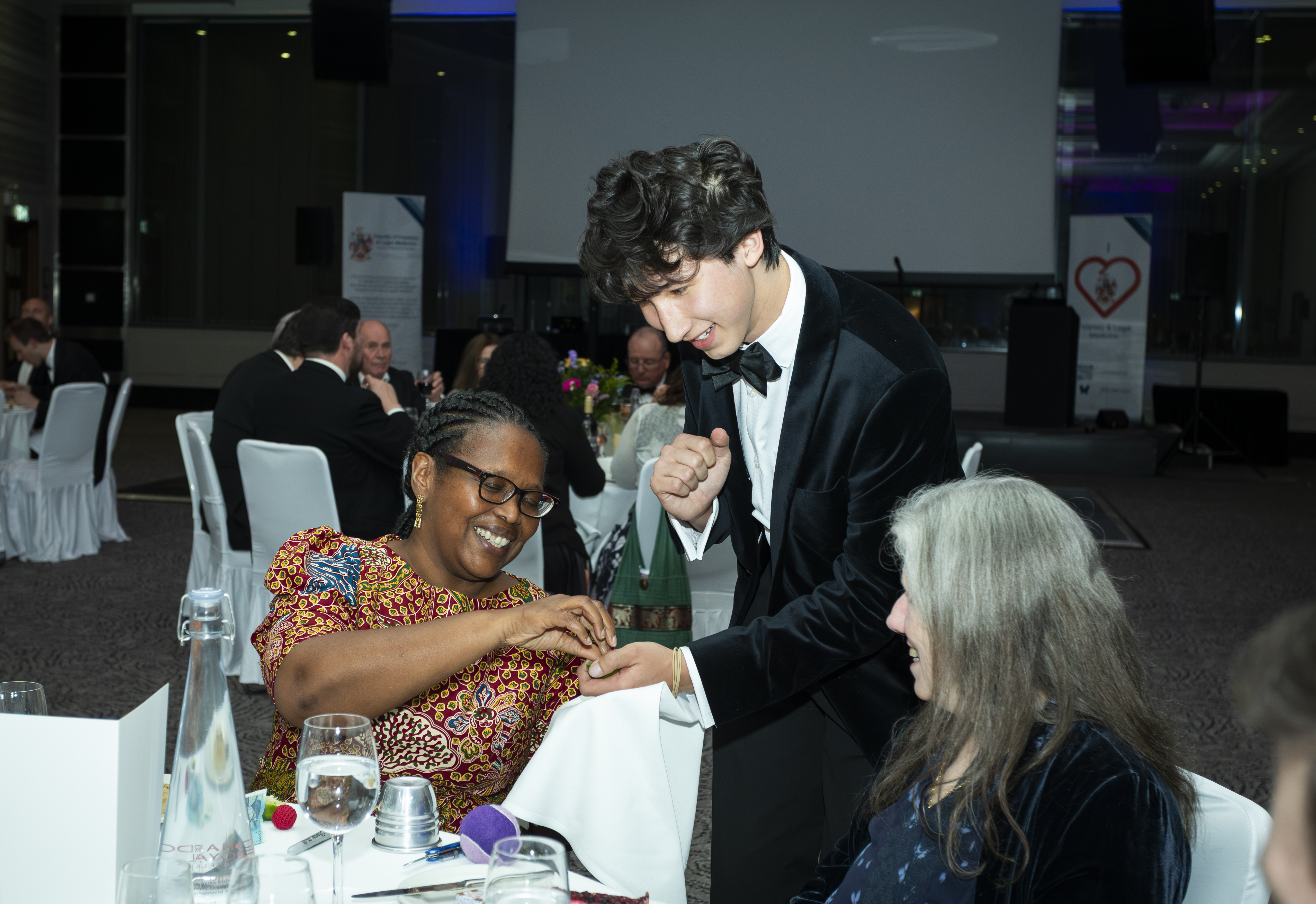 Noah performing close-up magic at a party